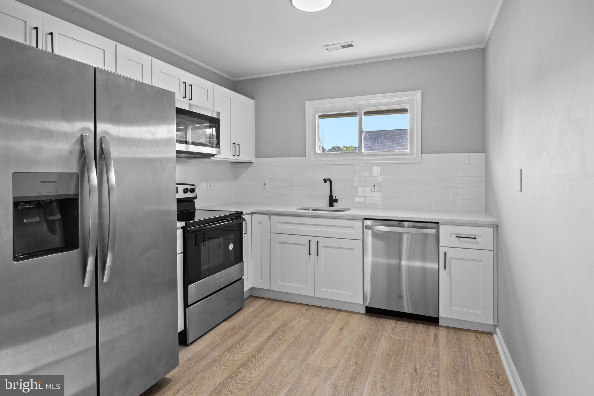 28 Gooseneck Road Levittown, PA 19057 - Photo 8 of 23 a kitchen with stainless steel appliances a refrigerator sink and microwave