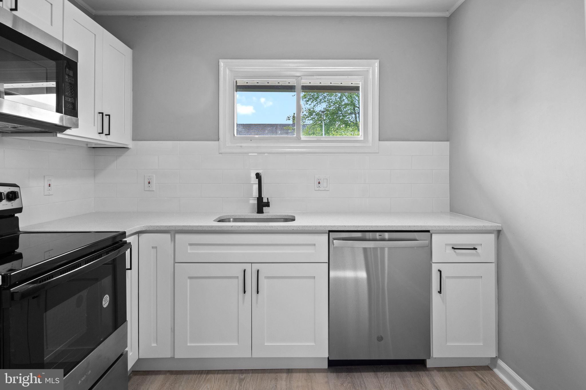 28 Gooseneck Road Levittown, PA 19057 - Photo 10 of 23 a kitchen with white cabinets and sink