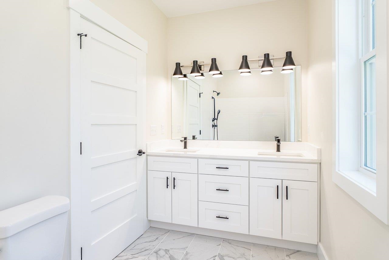 1378 Melrose Road Harrisonburg, VA 22802 - Photo 34 of 75 a bathroom with a double vanity sink a mirror and a bathtub