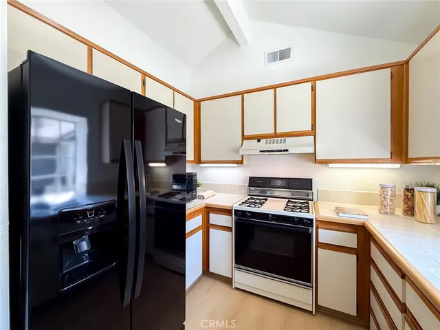 a bedroom with a bed and painting on the wall