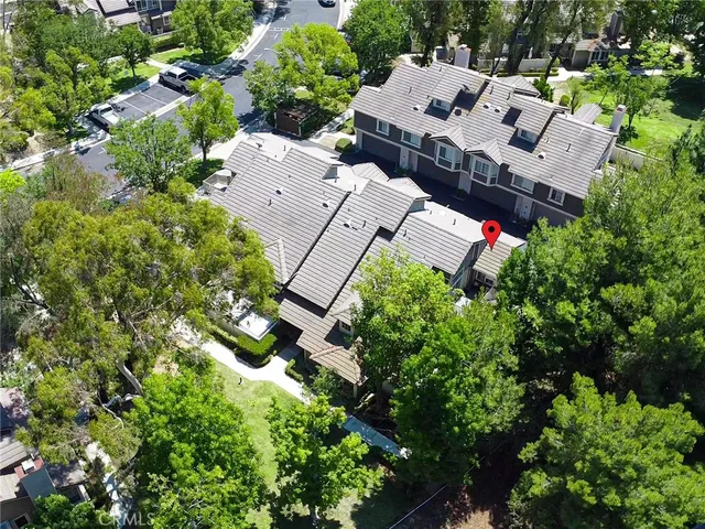 an aerial view of a houses with yard