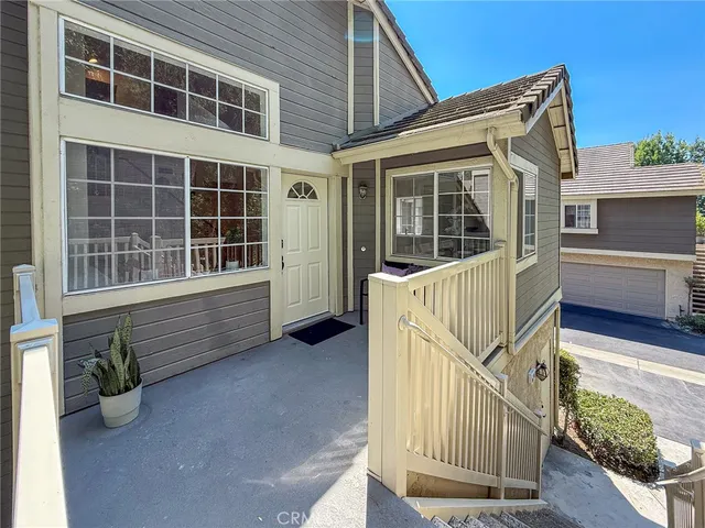 a balcony with wooden floor and outdoor seating