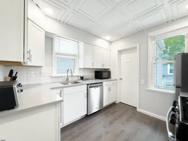a kitchen with a sink stove and cabinets