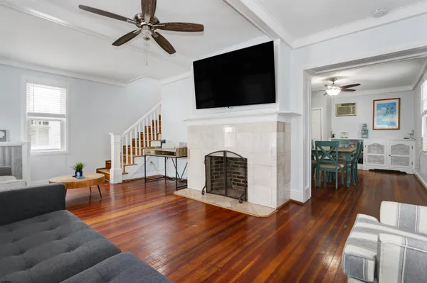a living room with fireplace furniture and a flat screen tv