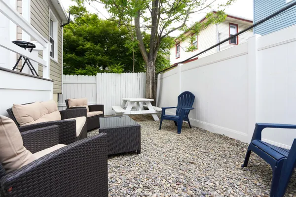 a backyard of a house with outdoor seating
