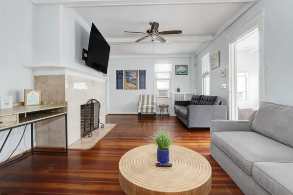 a living room with fireplace furniture and a wooden floor