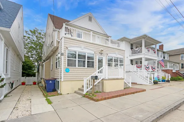 a front view of a house with a basket ball court and a fire pit