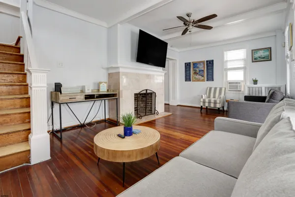a living room with furniture and a fireplace