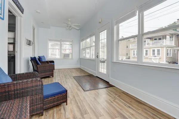 a living room with furniture and wooden floor