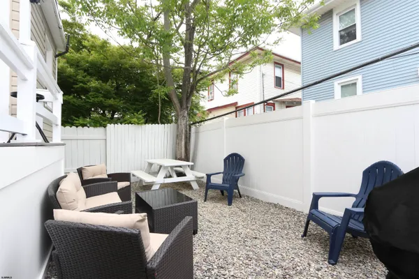 a backyard of a house with table and chairs