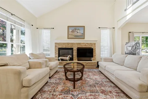 a living room with furniture a rug and a fireplace
