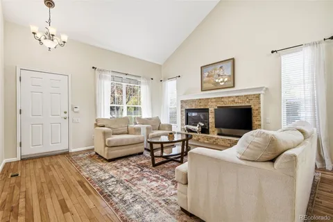 a living room with furniture a fireplace and a window