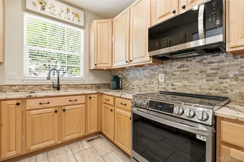 a kitchen with a stove microwave and sink