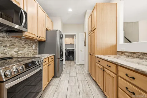 a kitchen with stainless steel appliances granite countertop a stove sink and cabinets