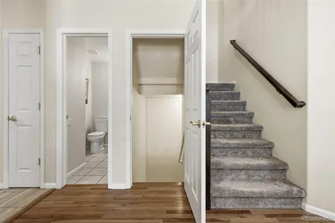 a view of an entryway with wooden floor and staircase