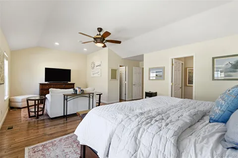 a bedroom with furniture and a flat screen tv