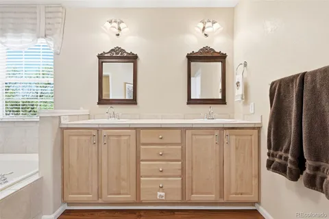 a bathroom with a double vanity sink and a mirror