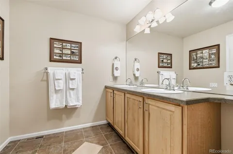 a bathroom with sinks a vanity and a large mirror