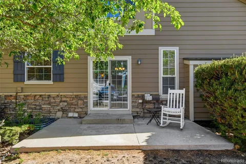 a view of house with backyard and outdoor seating