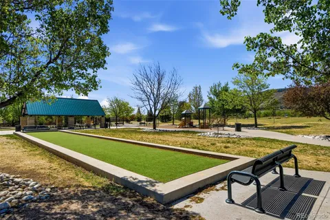 a view of a swimming pool with lawn chairs under an umbrella