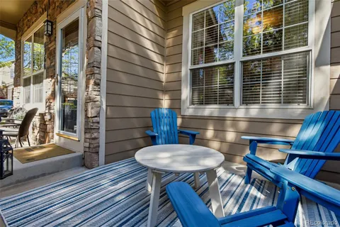 a view of a balcony with chairs and wooden floor