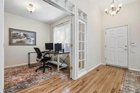 a view of a workspace with wooden floor and a workspace