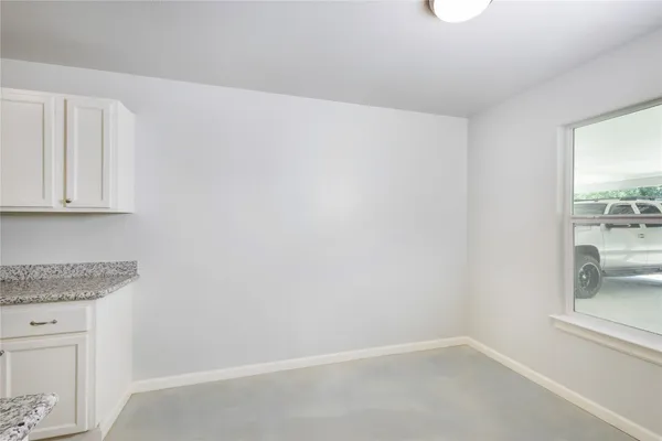 a kitchen with white cabinets and white appliances