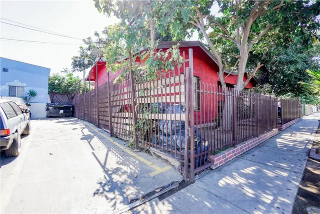 a view of balcony with small garden and wooden fence