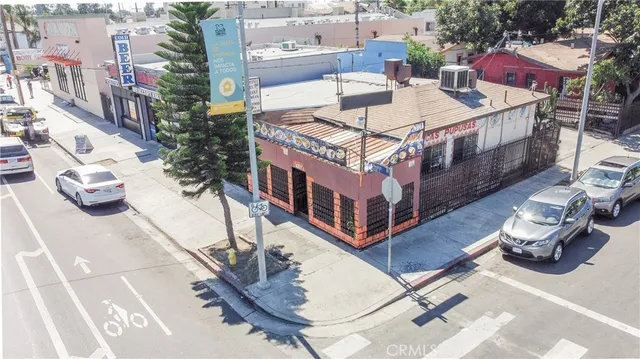 an aerial view of a house with roof deck and furniture