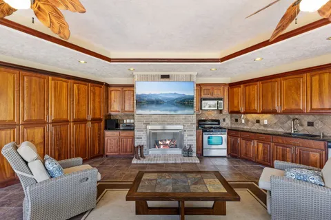 a kitchen with a stove and white cabinets