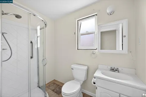 a bathroom with a toilet sink shower and mirror