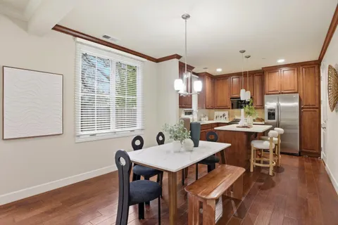 a kitchen with a table chairs refrigerator and microwave