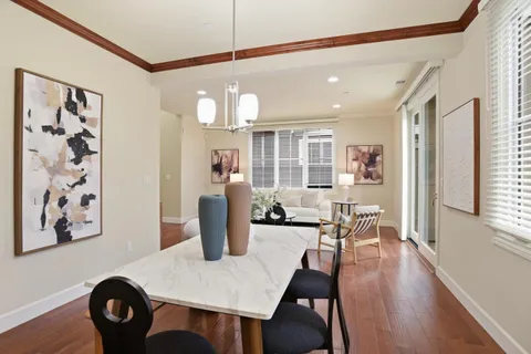 a view of a dining room with furniture and wooden floor