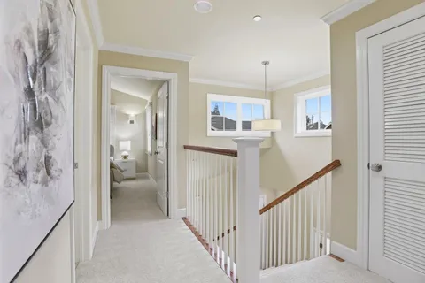 a view of a hallway with a livingroom and a bathroom