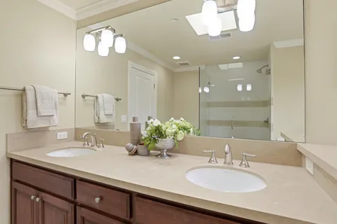 a bathroom with a sink double vanity and a mirror