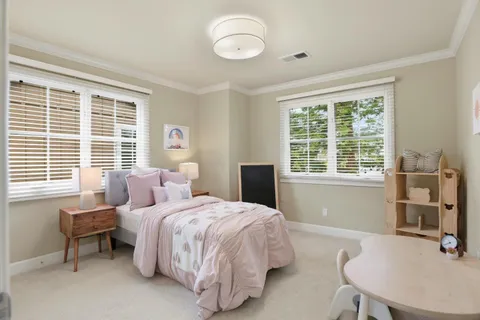 a bedroom with a bed and a table with chair