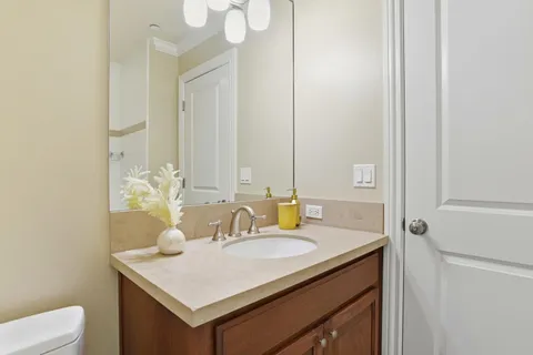 a bathroom with a sink vanity granite and a mirror