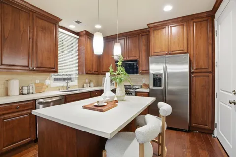 a kitchen with refrigerator cabinets dining table and chairs