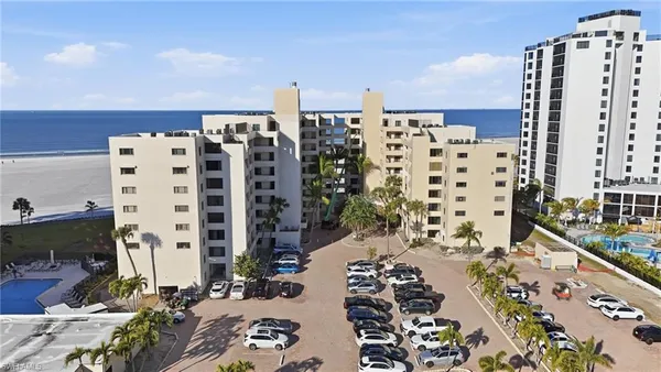 a view of parking with tall buildings
