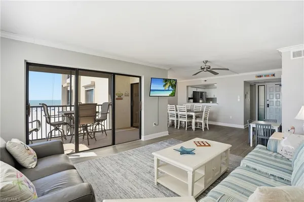 a living room with furniture and a table with garden view