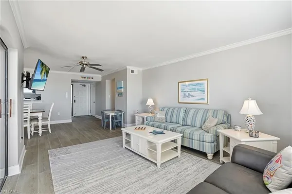 a living room with furniture and a wooden floor