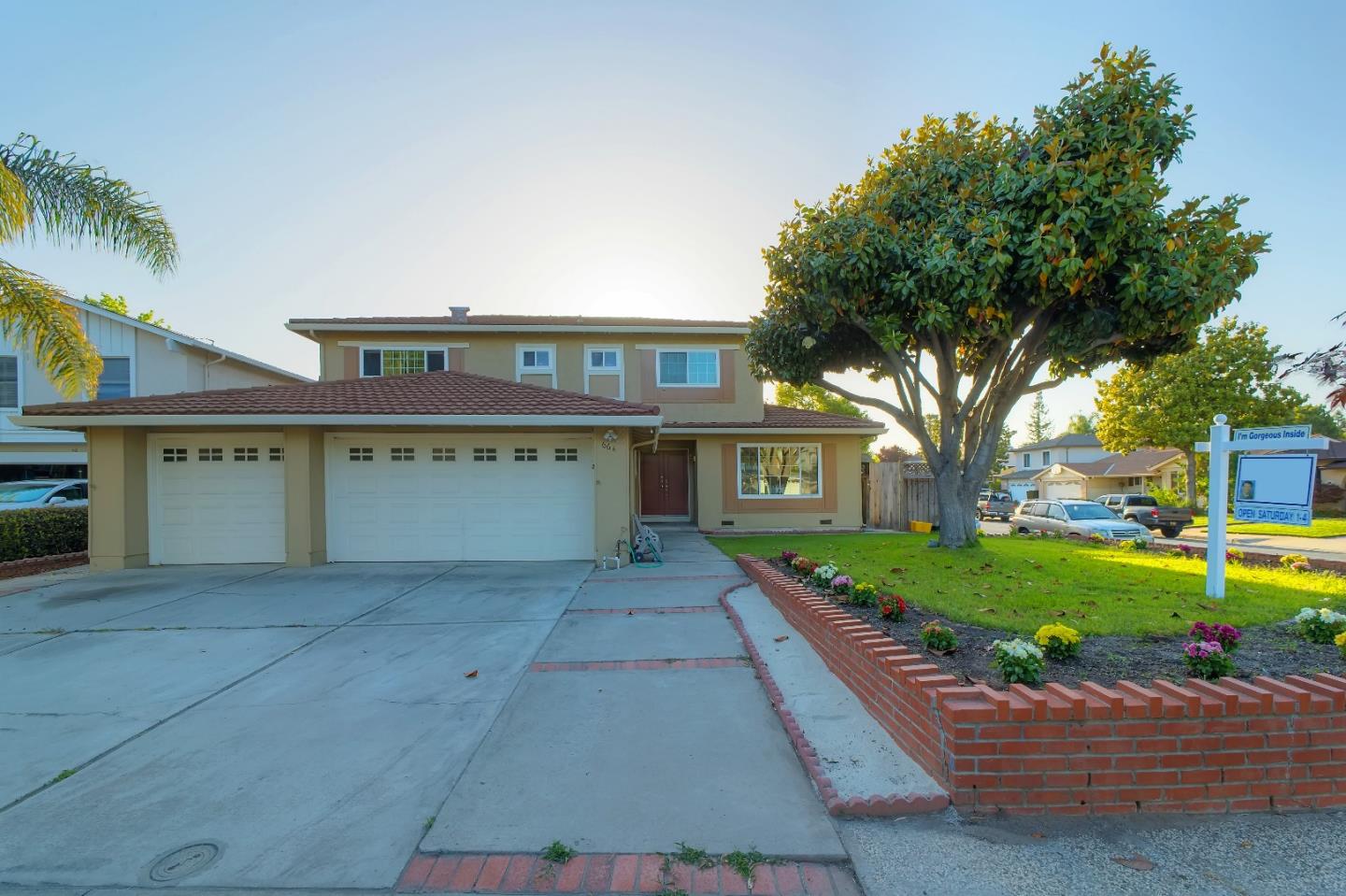 a view of a house with a yard and potted plants