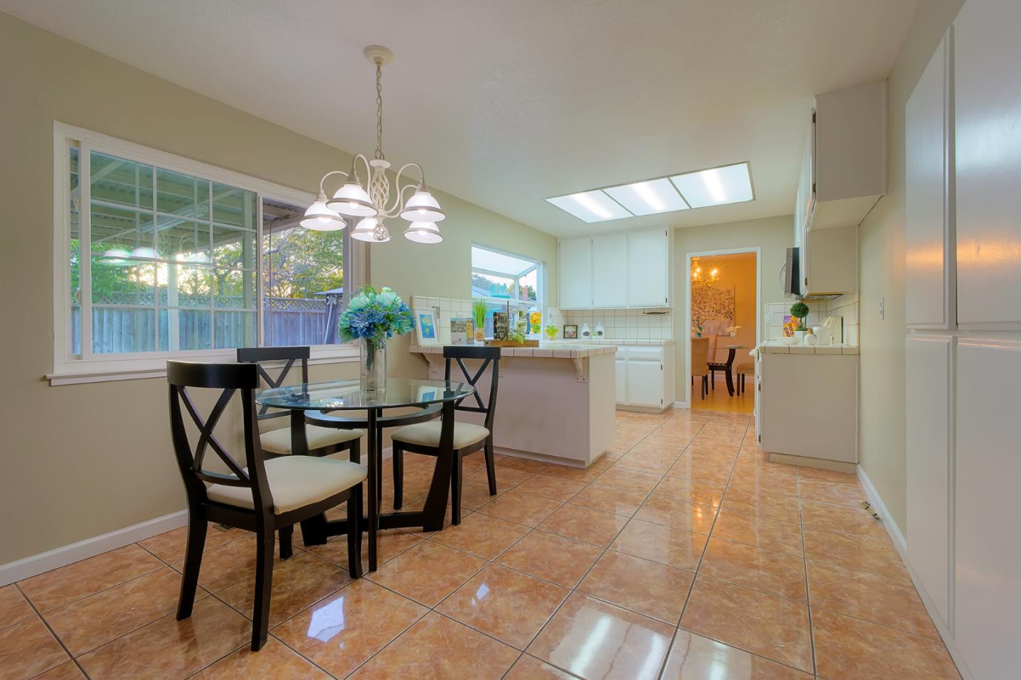 664 New Compton Drive San Jose, CA 95136 - Photo 15 of 26 a dining room filled a chandelier and kitchen view