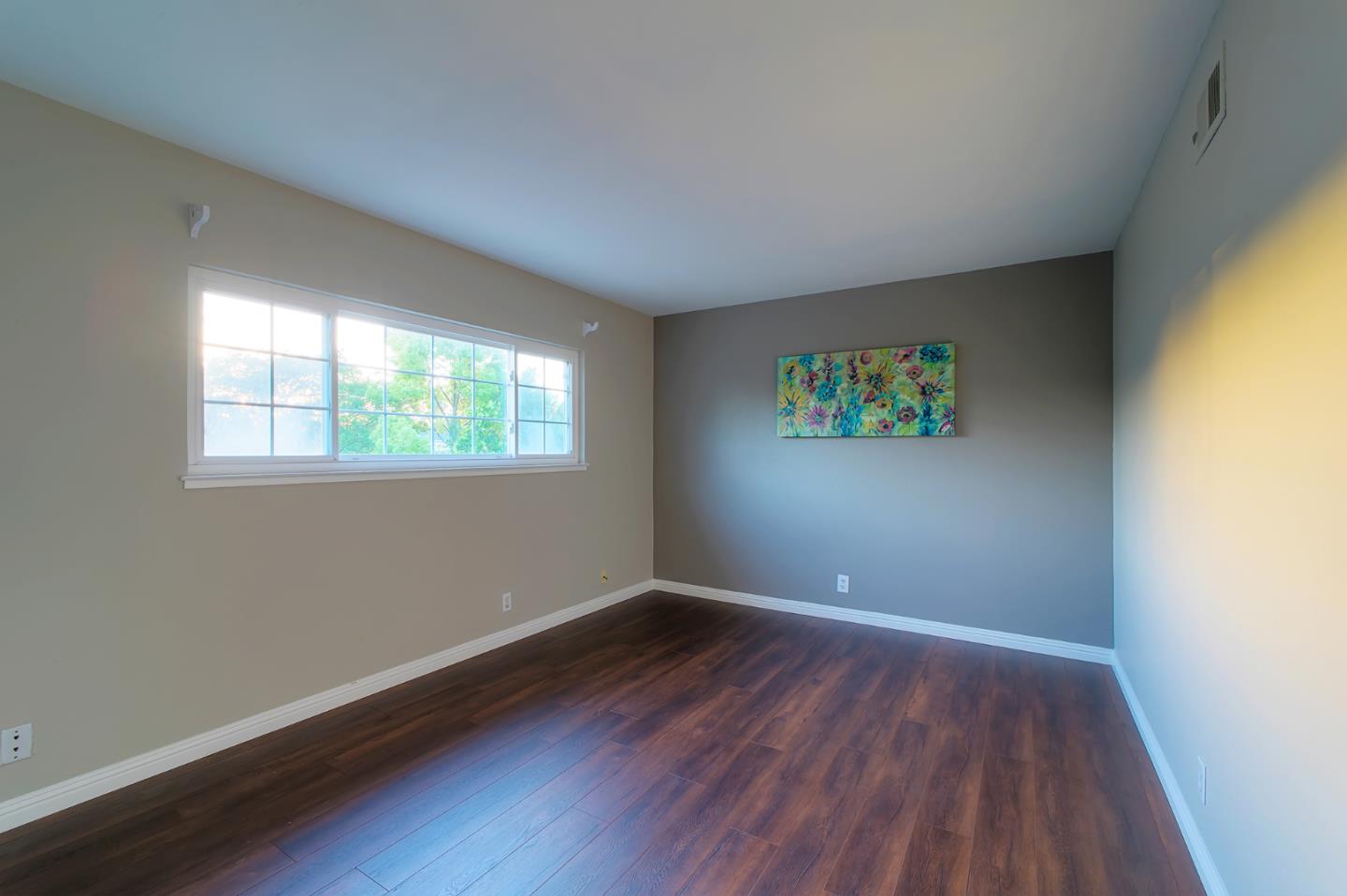 664 New Compton Drive San Jose, CA 95136 - Photo 21 of 26 an empty room with wooden floor and windows