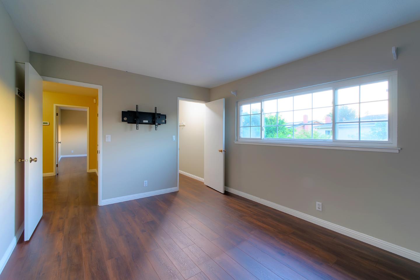 664 New Compton Drive San Jose, CA 95136 - Photo 22 of 26 an empty room with wooden floor and windows