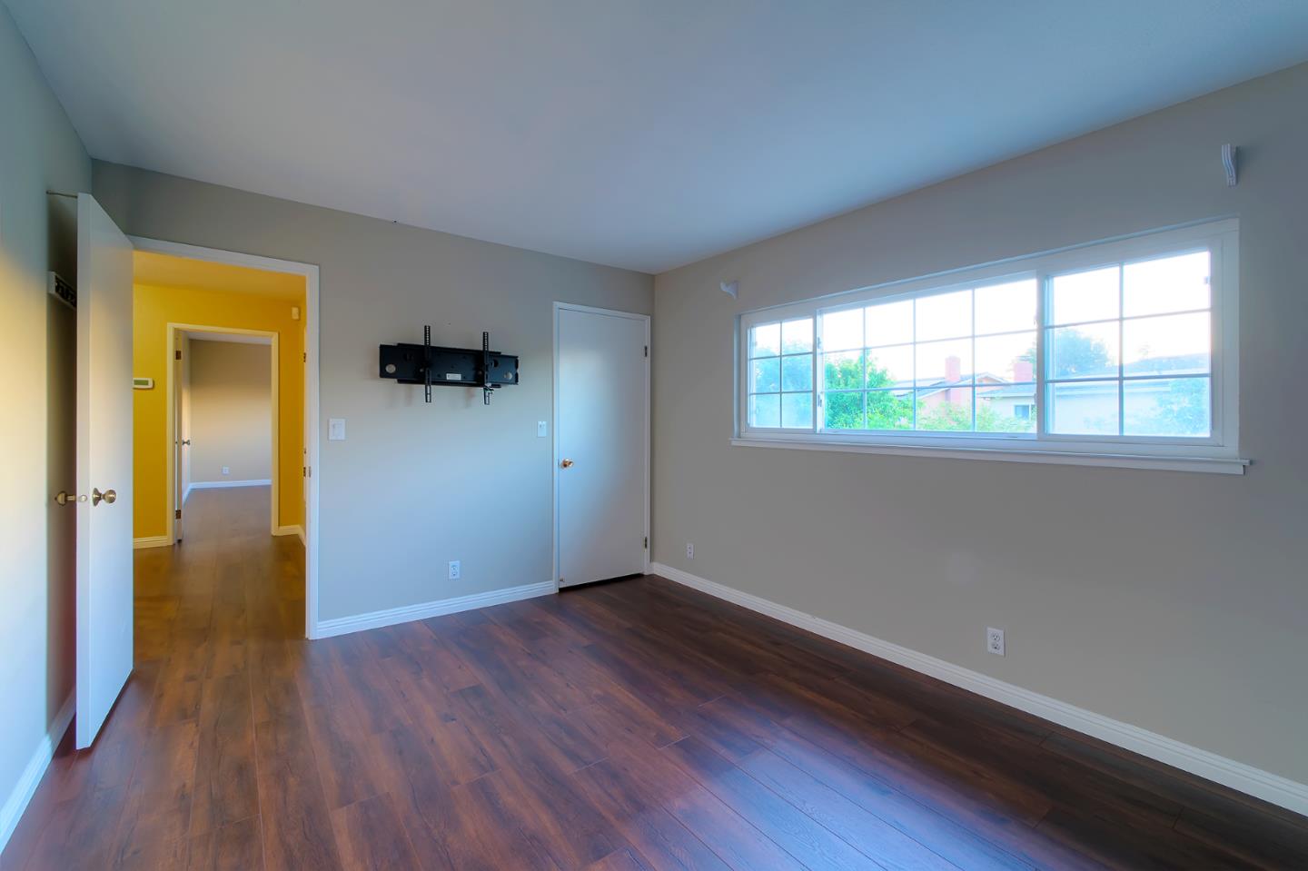 664 New Compton Drive San Jose, CA 95136 - Photo 23 of 26 an empty room with wooden floor and windows