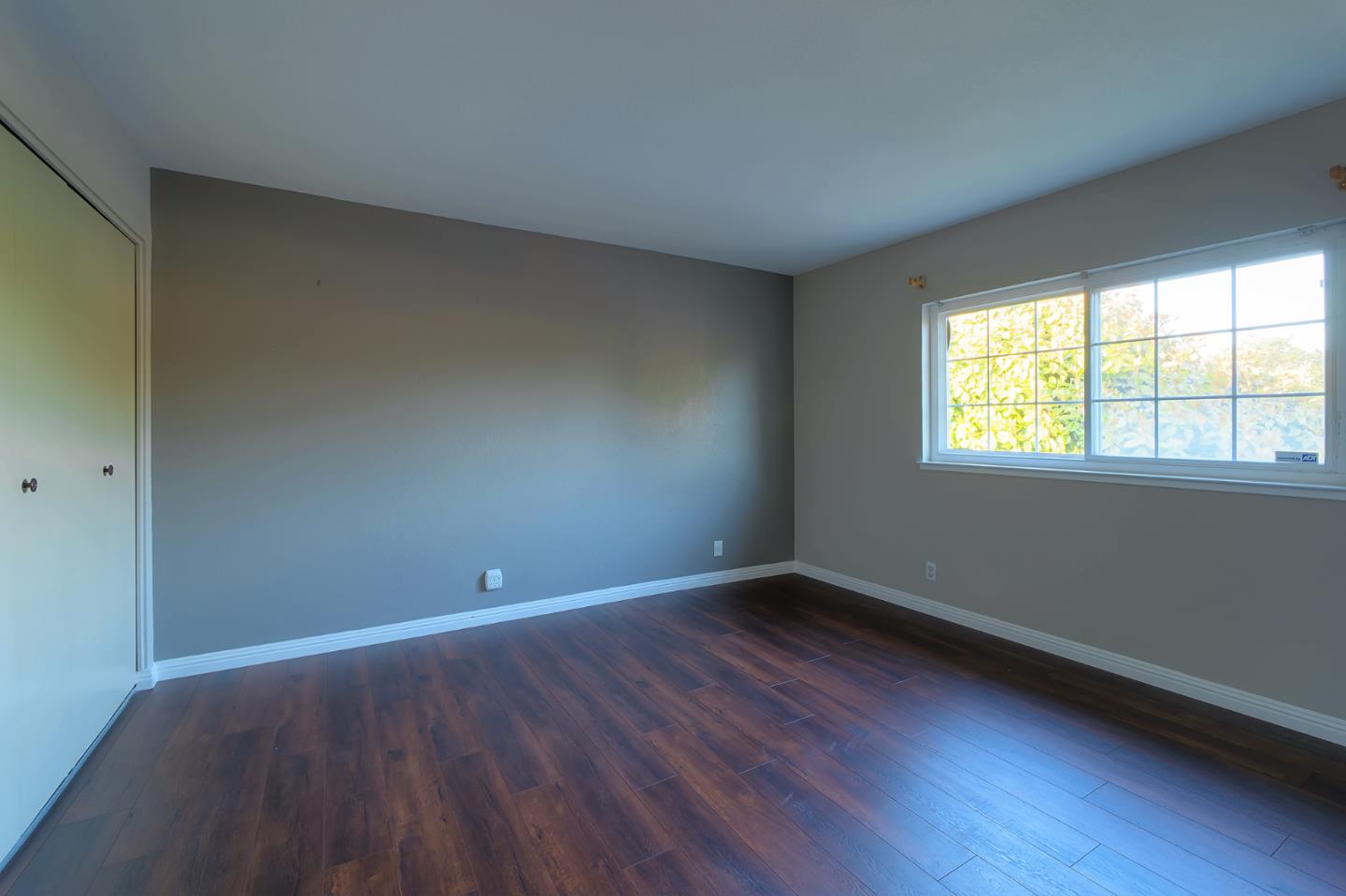 664 New Compton Drive San Jose, CA 95136 - Photo 8 of 26 a view of an empty room with wooden floor and a window
