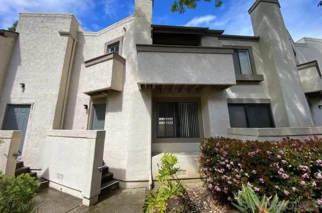 front view of a house with a potted plant