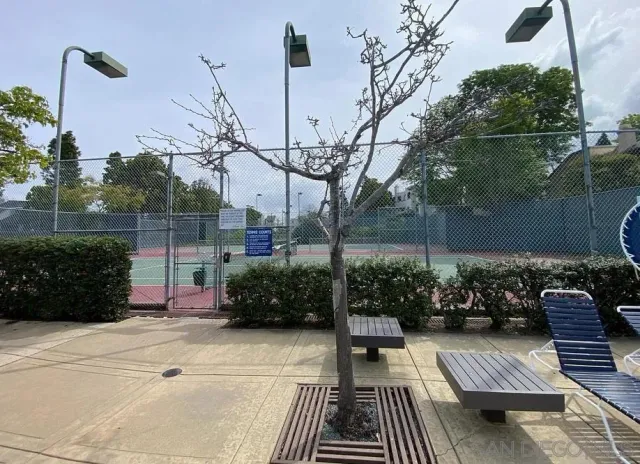 a dining room with furniture a chandelier and a floor to ceiling window