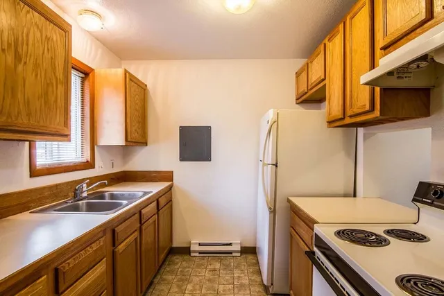a kitchen that has a sink and a stove